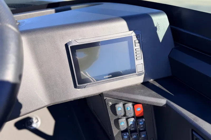 Slide: The Image of 2025 Alumacraft Competitor 185X Sport dashboard with Garmin display and control panel. - 23