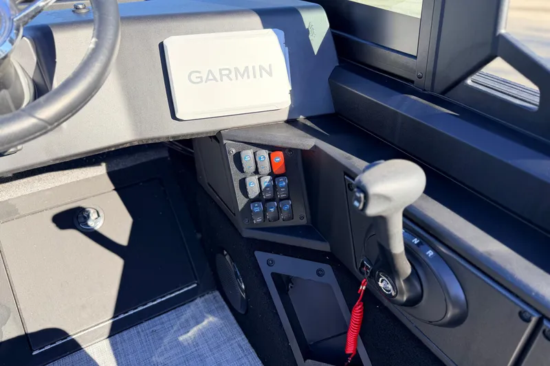 Slide: The Image of 2025 Alumacraft Competitor 185X Sport dashboard with Garmin navigation and control panel. - 24