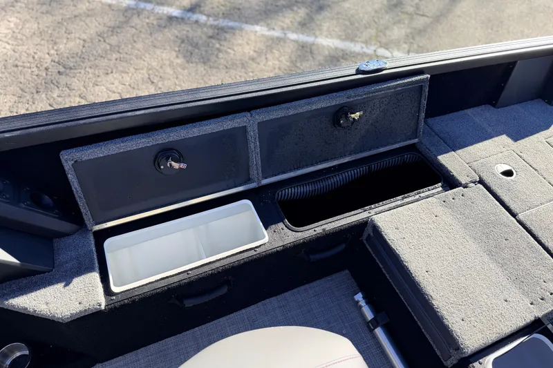 Slide: The Image of 2025 Alumacraft Competitor 185X Sport boat interior storage compartments. - 32