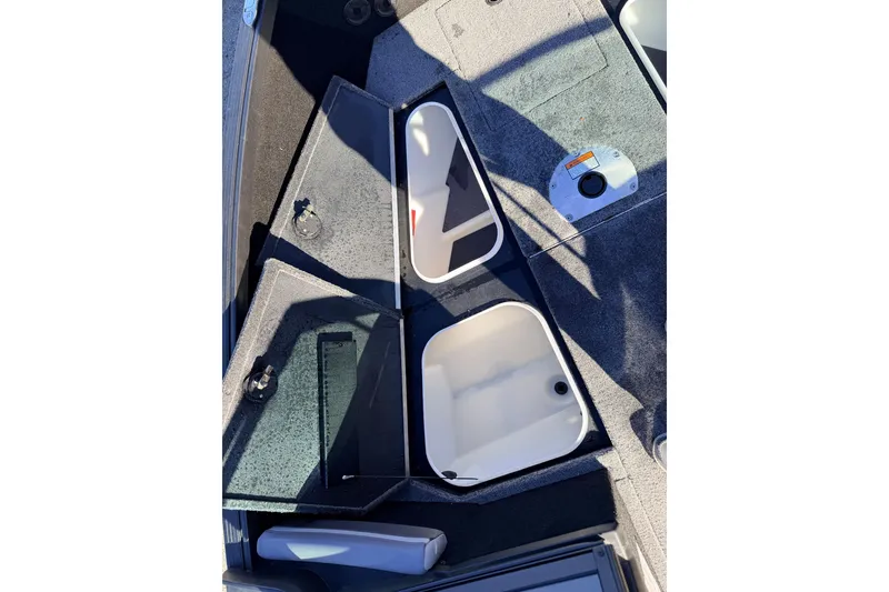 Slide: The Image of 2025 Alumacraft Competitor 185X Sport boat interior storage compartments open. - 42