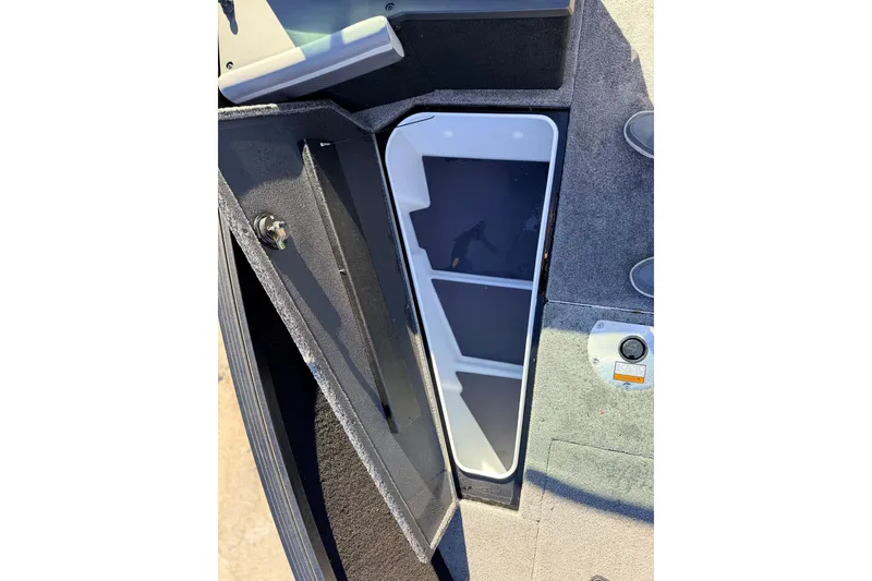 Slide: The Image of 2025 Alumacraft Competitor 185X Sport boat storage compartment with open hatch. - 43