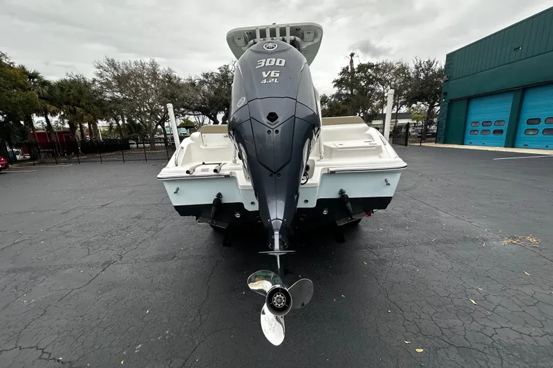 Slide: The Image of 2023 Key West 239 FS boat with powerful 300 V6 engine, parked outdoors. - 3