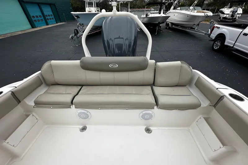 Slide: The Image of 2023 Key West 239 FS boat interior with cushioned seating and cup holders. - 5