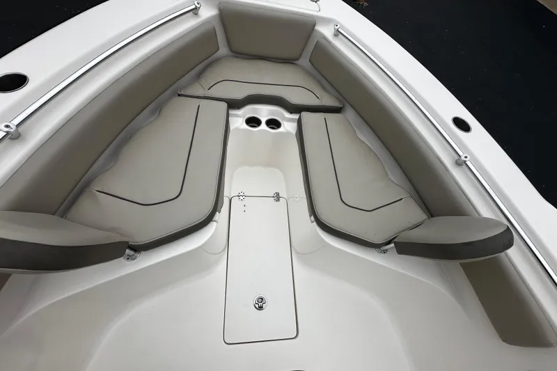 Slide: The Image of 2023 Key West 239 FS boat interior with cushioned seating and cup holders. - 7