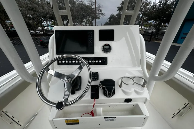 Slide: The Image of 2023 Key West 239 FS boat console with steering wheel and navigation equipment. - 9