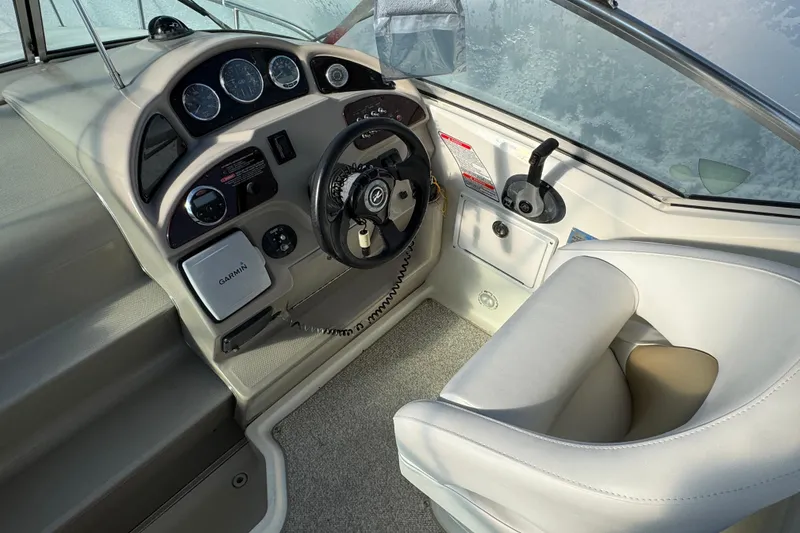 Slide: The Image of Interior helm of 2006 Sea Ray Sundancer 280 with steering wheel and navigation equipment. - 10