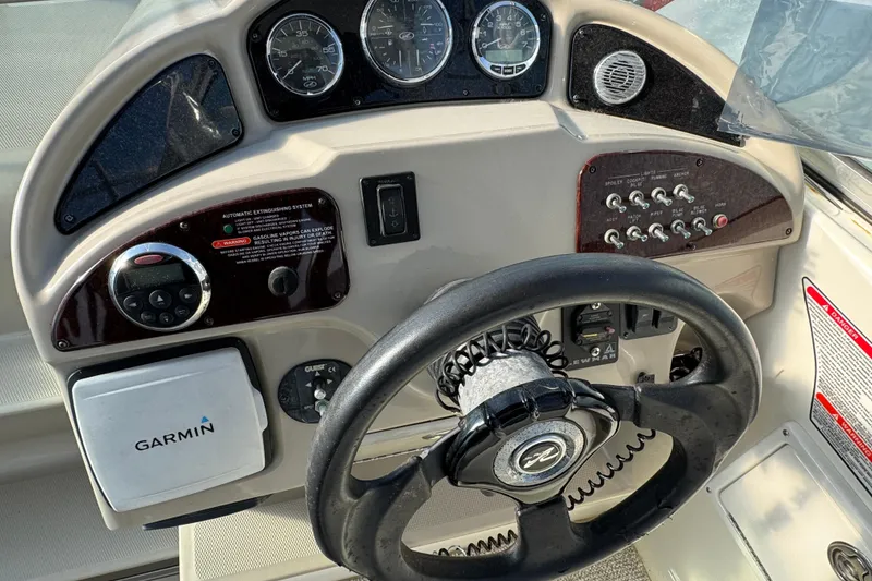 Slide: The Image of 2006 Sea Ray Sundancer 280 dashboard with Garmin GPS and control panel. - 11