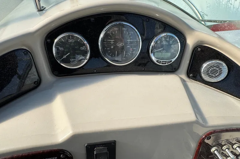 Slide: The Image of Dashboard of a 2006 Sea Ray Sundancer 280 boat with gauges and controls. - 12