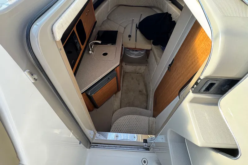 Slide: The Image of Interior view of 2006 Sea Ray Sundancer 280 cabin with kitchenette and seating area. - 15