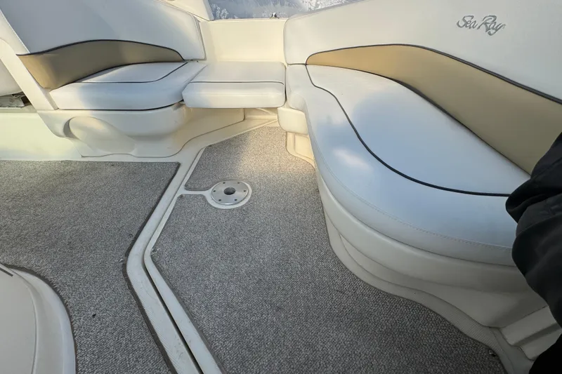 Slide: The Image of Interior seating of a 2006 Sea Ray Sundancer 280 boat, featuring white and beige upholstery. - 3
