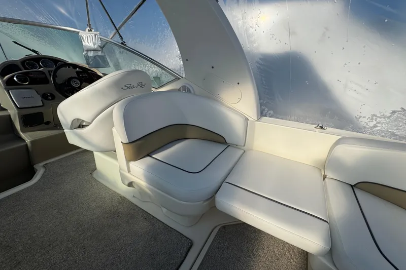 Slide: The Image of 2006 Sea Ray Sundancer 280 interior with white seating and helm, showcasing luxury design. - 5