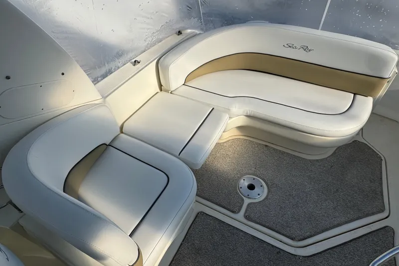 Slide: The Image of 2006 Sea Ray Sundancer 280 interior with white leather seating and carpeted floor. - 6