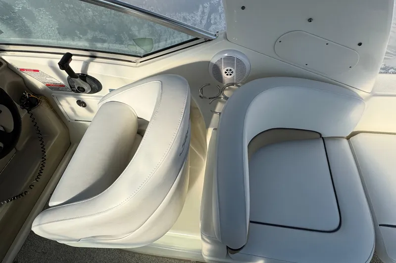 Slide: The Image of 2006 Sea Ray Sundancer 280 cockpit with white seating and control panel. - 9