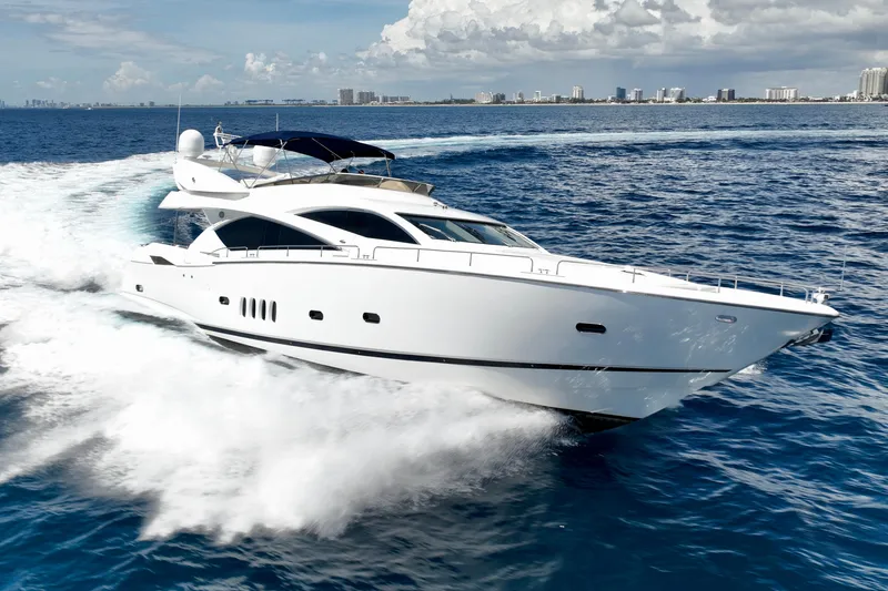 The Image of 2005 Sunseeker 82 Yacht cruising on open water, city skyline in background. - 1