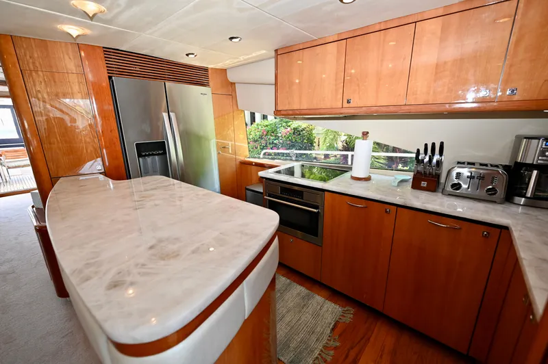 Slide: The Image of Luxurious kitchen interior of a 2005 Sunseeker 82 Yacht with modern appliances and wood cabinetry. - 15