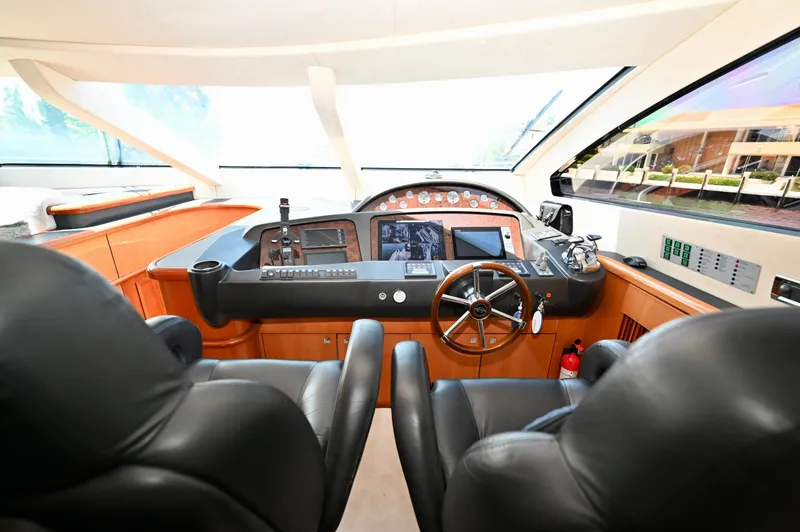 Slide: The Image of Luxurious 2005 Sunseeker 82 Yacht helm with leather seats and advanced navigation controls. - 19