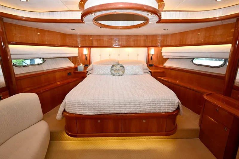 Slide: The Image of Luxurious bedroom interior of a 2005 Sunseeker 82 Yacht with elegant wood finishes. - 25