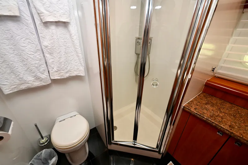 Slide: The Image of Luxurious bathroom on 2005 Sunseeker 82 Yacht with shower, toilet, and elegant wood cabinetry. - 29