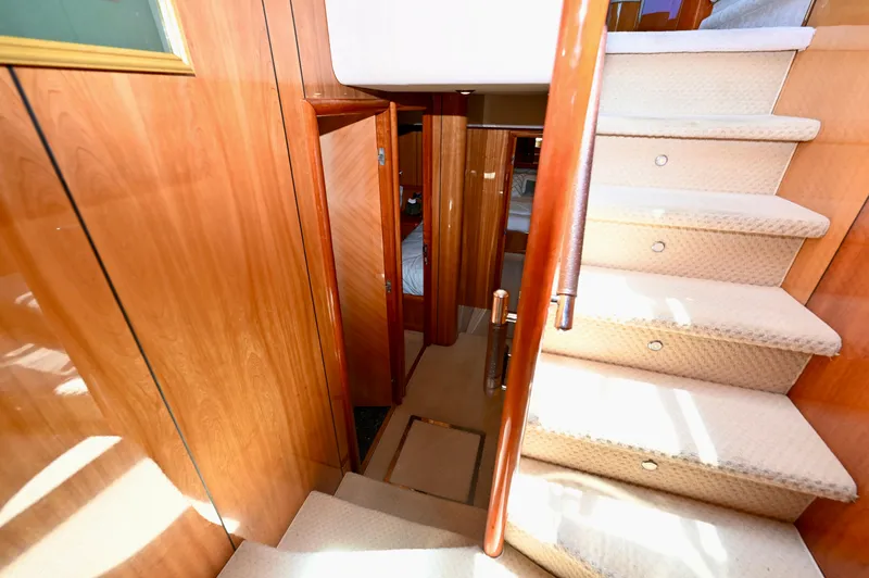 Slide: The Image of Interior staircase of 2005 Sunseeker 82 Yacht with wooden paneling and carpeted steps. - 31