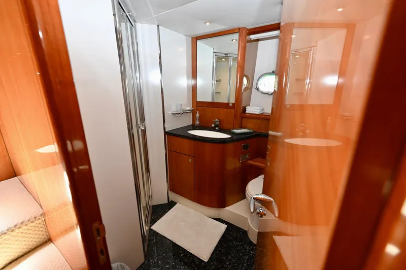 Slide: The Image of Luxurious bathroom on a 2005 Sunseeker 82 Yacht with modern fixtures and wood accents. - 34