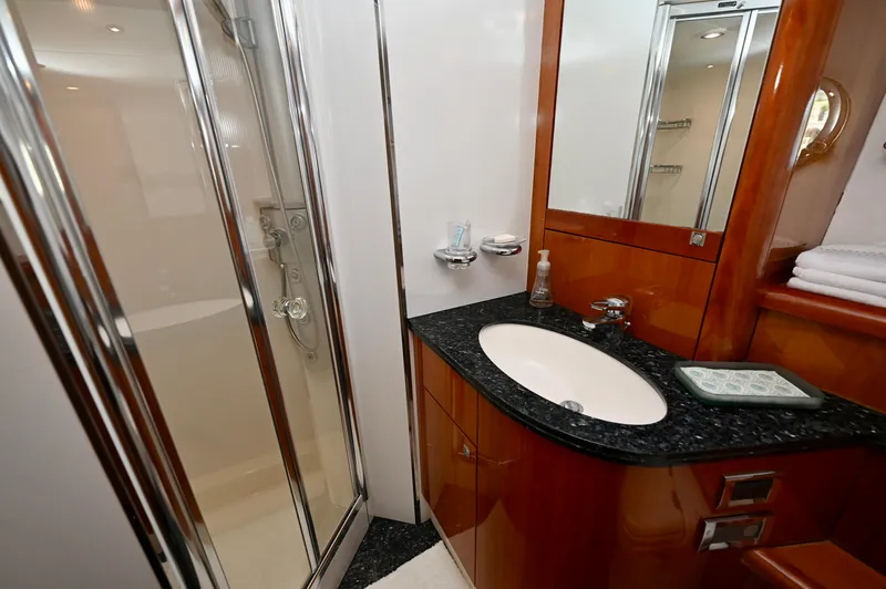 Slide: The Image of Luxurious bathroom in a 2005 Sunseeker 82 Yacht, featuring elegant wood and chrome finishes. - 35