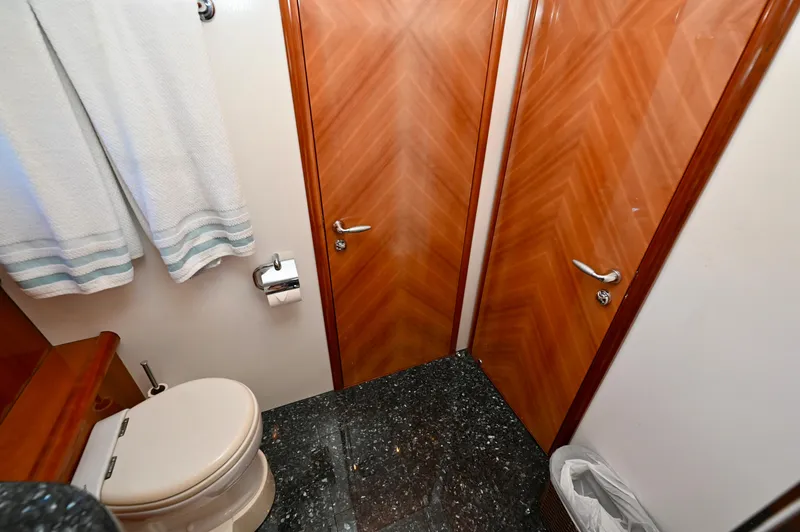 Slide: The Image of Luxurious bathroom on a 2005 Sunseeker 82 Yacht with elegant wood doors and marble flooring. - 36