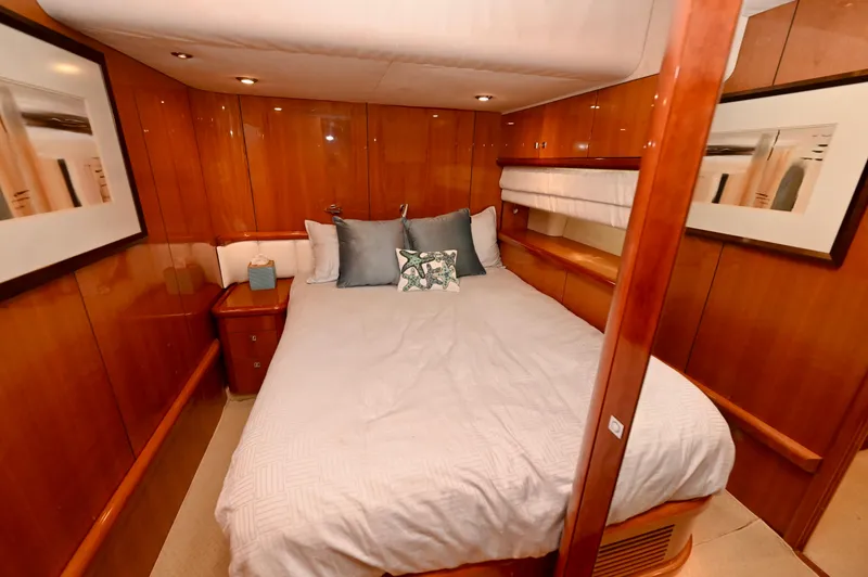 Slide: The Image of Luxurious cabin interior of a 2005 Sunseeker 82 Yacht with wood paneling and cozy bedding. - 37