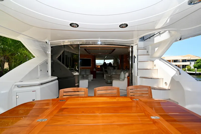 Slide: The Image of Luxurious 2005 Sunseeker 82 Yacht interior with elegant wooden dining table and spacious seating area. - 7