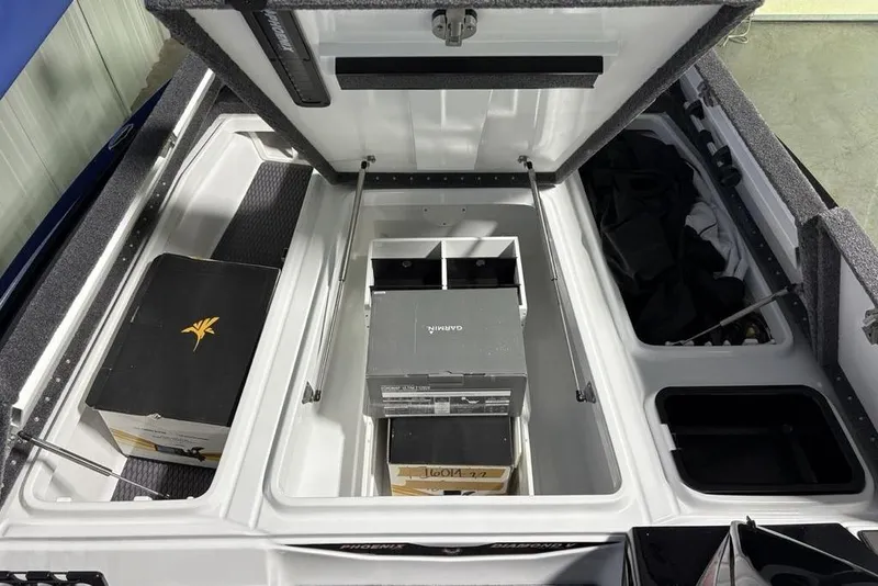 Slide: The Image of 2026 Phoenix 20 XE boat storage compartments with organized gear and equipment. - 11