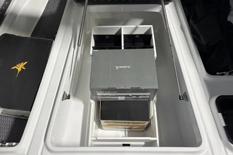Slide: The Image of Storage compartment in 2026 Phoenix 20 XE boat with Garmin equipment boxes. - 14