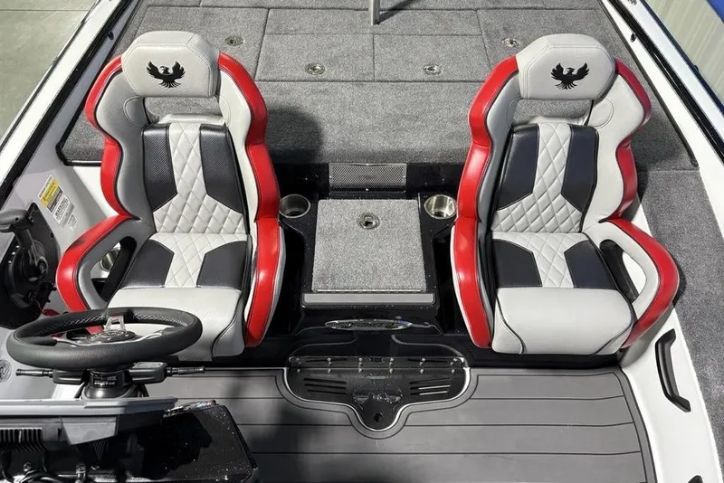 Slide: The Image of 2026 Phoenix 20 XE boat interior with red and black seats, steering wheel, and carpeted flooring. - 20