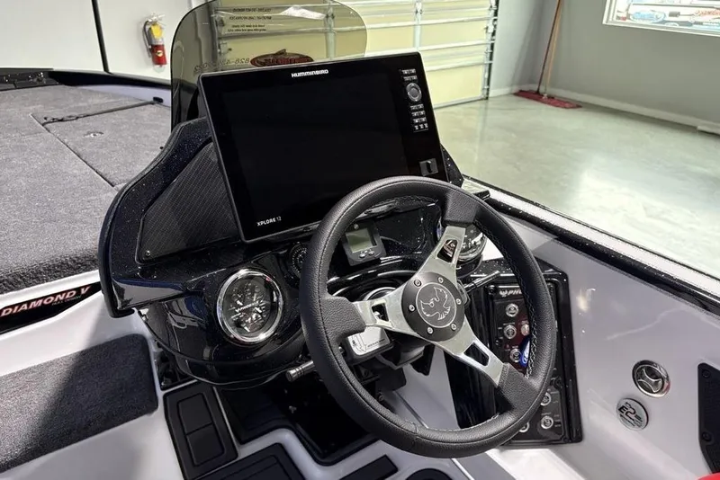 Slide: The Image of 2026 Phoenix 20 XE boat dashboard with steering wheel and digital display. - 23