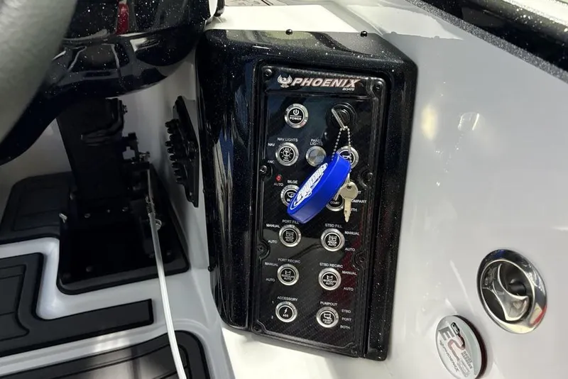 Slide: The Image of Control panel of 2026 Phoenix 20 XE boat with key and switches. - 29