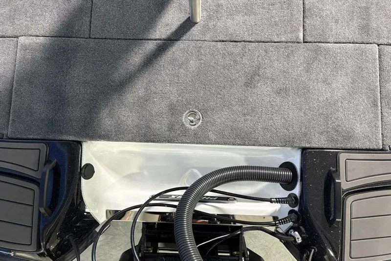 Slide: The Image of 2026 Phoenix 20 XE boat deck with gray carpeting and visible wiring. - 33