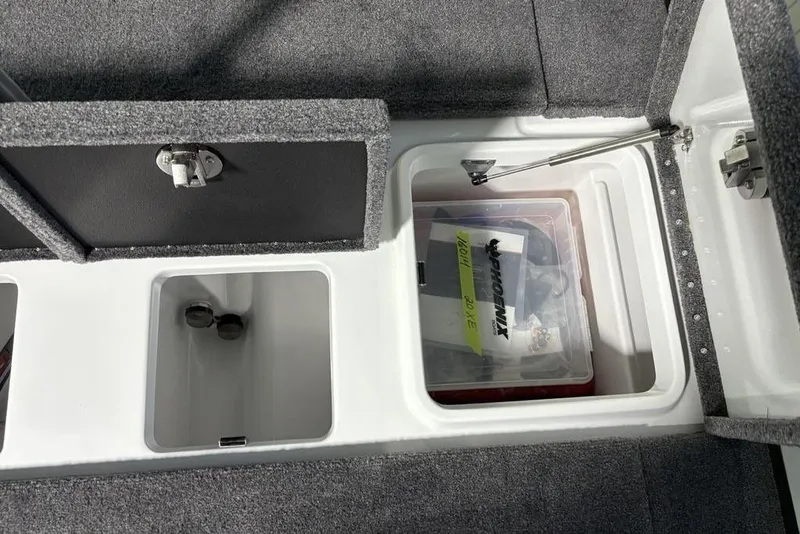 Slide: The Image of Storage compartments in a 2026 Phoenix 20 XE boat, featuring organized interior spaces. - 34