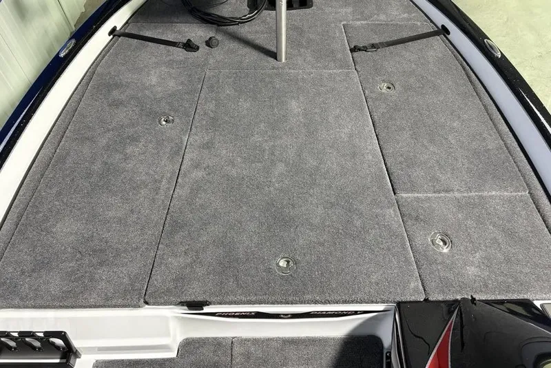 Slide: The Image of 2026 Phoenix 20 XE boat deck with gray carpet and storage compartments. - 9