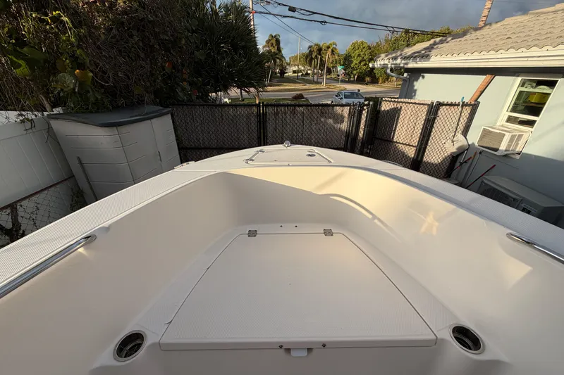 Slide: The Image of 2018 Robalo R180 Center Console boat, bow view, parked in residential area. - 12
