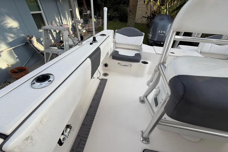 Slide: The Image of 2018 Robalo R180 Center Console boat interior with seating and Yamaha 115 engine. - 19