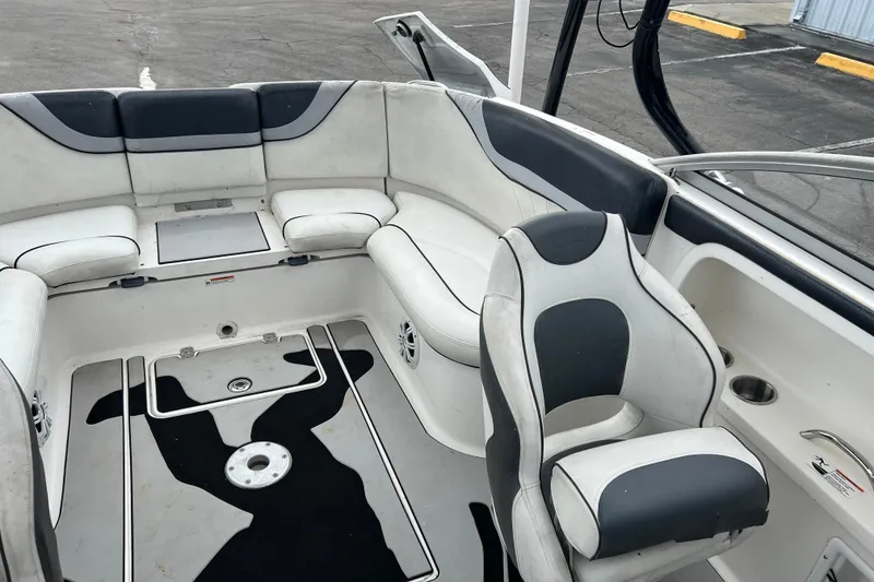 Slide: The Image of 2006 Yamaha Boats SX230 HO interior with white and black seating, spacious layout. - 18