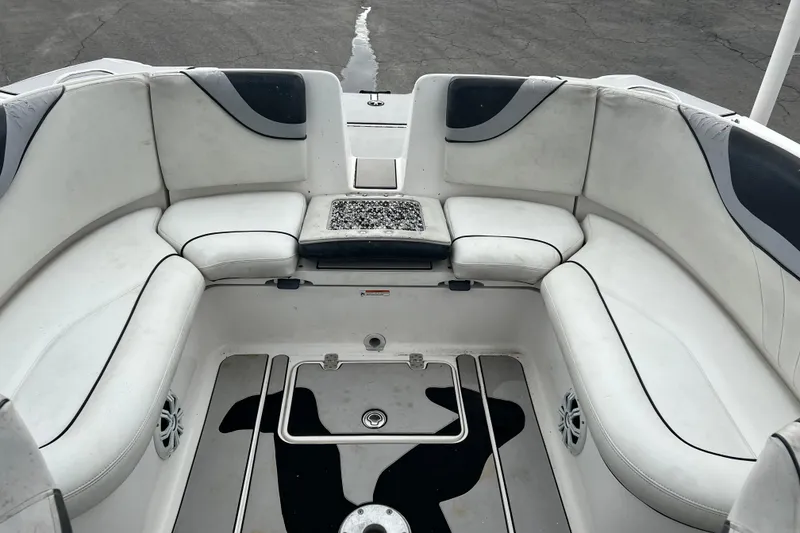 Slide: The Image of 2006 Yamaha Boats SX230 HO interior with white cushioned seating and storage compartments. - 19
