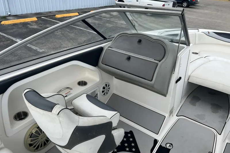 Slide: The Image of 2006 Yamaha Boats SX230 HO interior with seating, storage, and cup holders. - 21