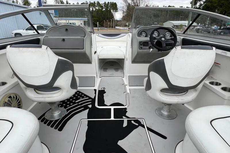 Slide: The Image of 2006 Yamaha Boats SX230 HO interior with steering wheel and seating arrangement. - 23