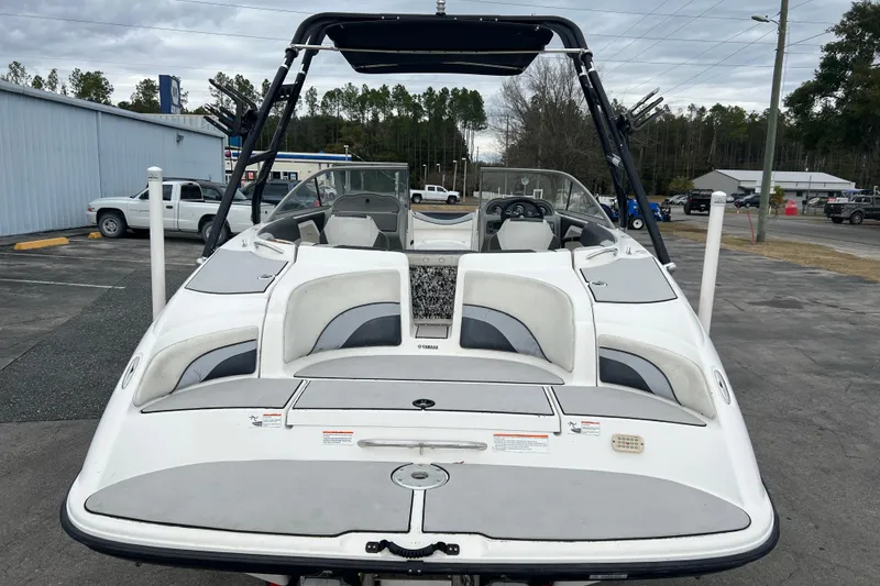 Slide: The Image of 2006 Yamaha Boats SX230 HO, white exterior, parked outdoors, showcasing seating and dashboard. - 31