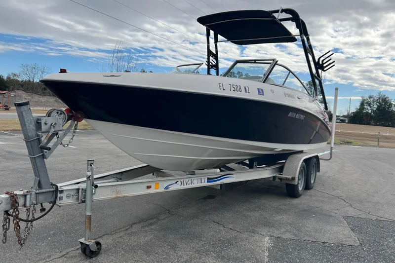 Slide: The Image of 2006 Yamaha Boats SX230 HO on trailer, parked outdoors under cloudy sky. - 32