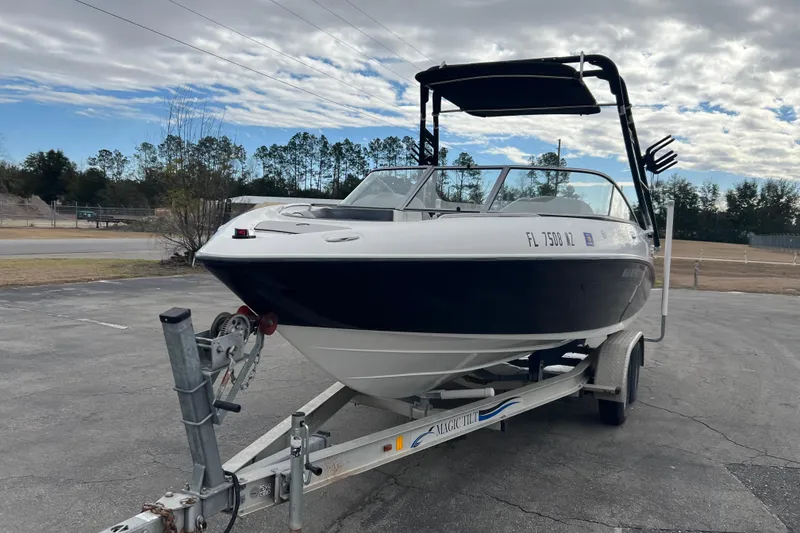Slide: The Image of 2006 Yamaha Boats SX230 HO on trailer, parked outdoors under cloudy sky. - 33