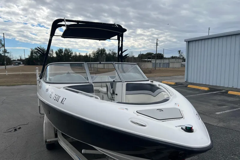 Slide: The Image of 2006 Yamaha Boats SX230 HO in a parking lot, showcasing sleek design and spacious interior. - 35