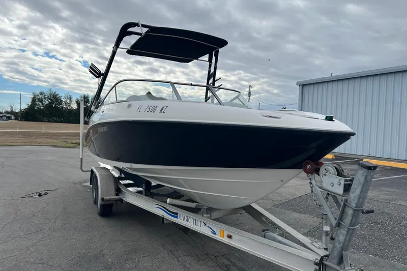 Slide: The Image of 2006 Yamaha Boats SX230 HO on trailer, parked outdoors under cloudy sky. - 36