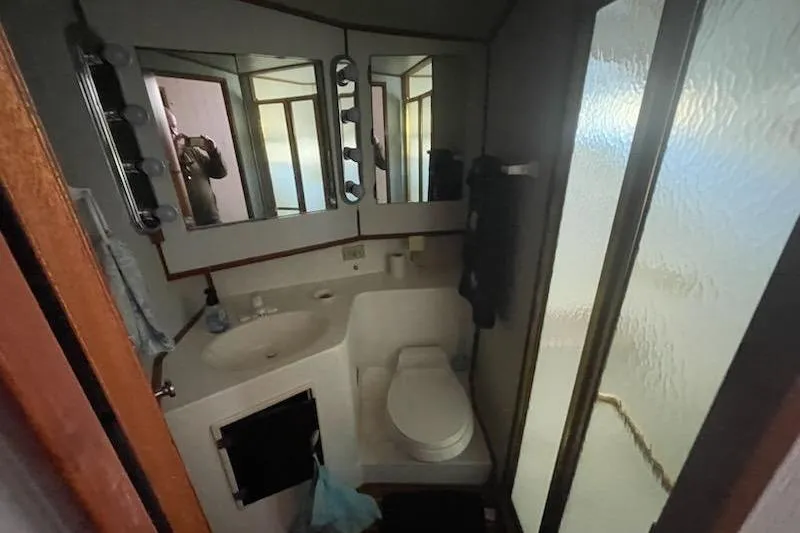 Slide: The Image of Bathroom interior of 1987 Topaz 44 Flybridge yacht with mirrors and shower. - 11