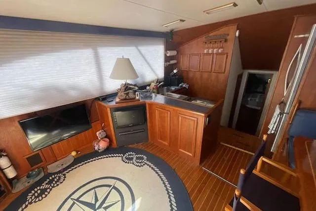Slide: The Image of Interior of 1987 Topaz 44 Flybridge yacht with wood paneling and nautical decor. - 4