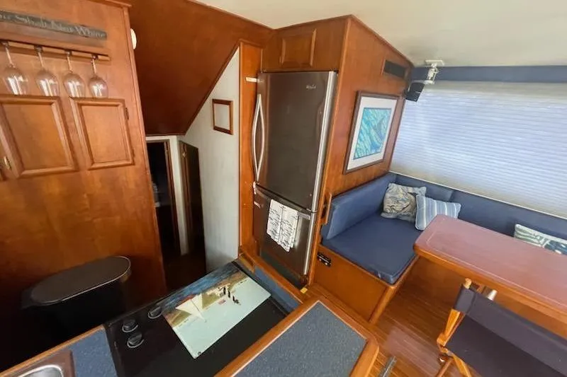 Slide: The Image of Interior of 1987 Topaz 44 Flybridge yacht with kitchen and seating area. - 6